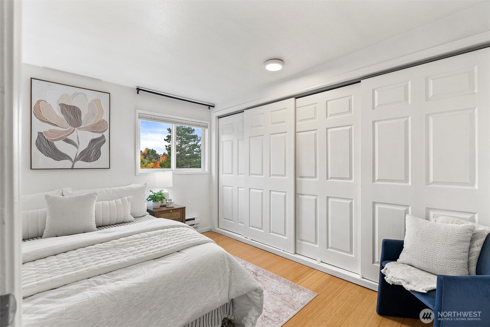 2626 East Madison Street, Unit 11 Seattle, WA 98112 - Photo 4 of 29 a spacious bedroom with a bed and a couch