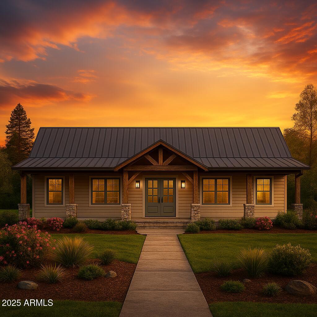 a front view of a house with a garden