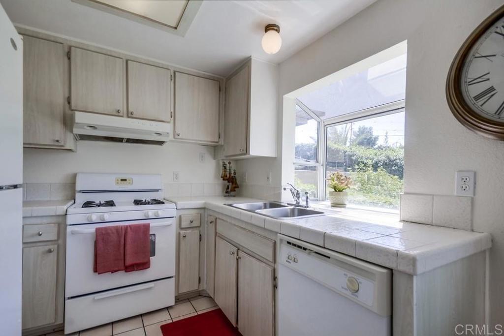 6454 Quarry Road, Unit 9 Spring Valley, CA 91977 - Photo 11 of 26 a kitchen with a stove a sink and a window