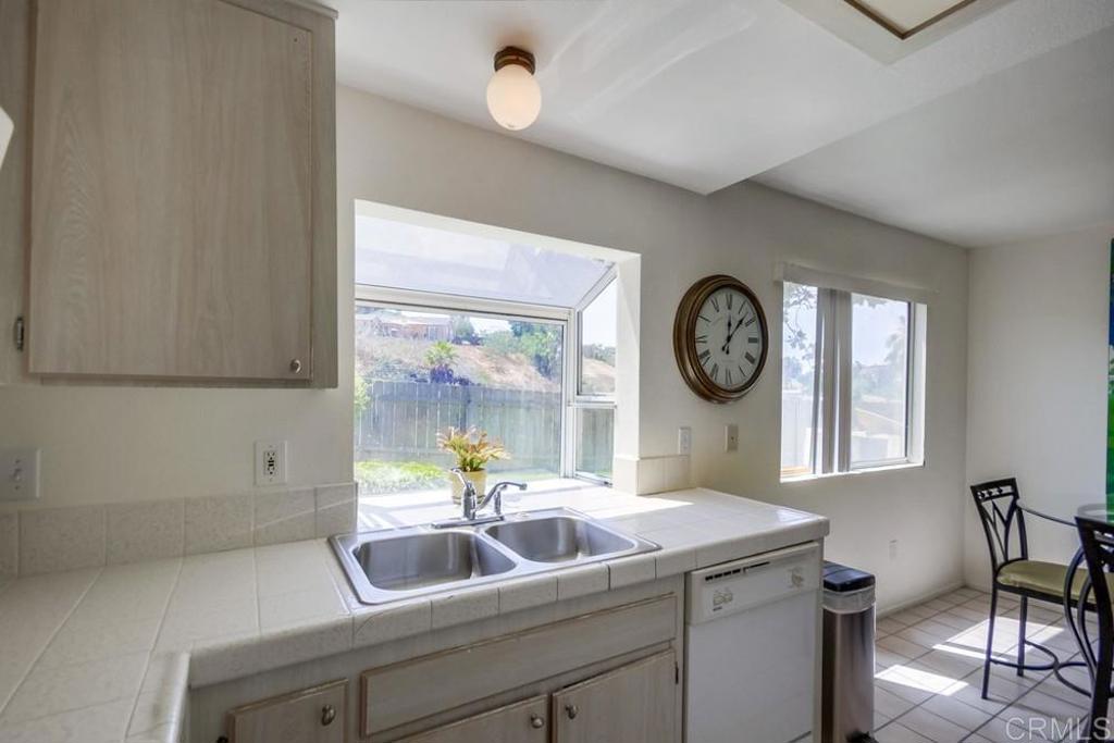 6454 Quarry Road, Unit 9 Spring Valley, CA 91977 - Photo 13 of 26 a bathroom with a sink a large mirror and a window