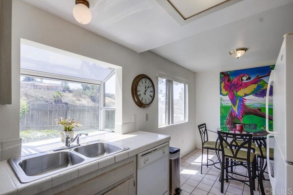 6454 Quarry Road, Unit 9 Spring Valley, CA 91977 - Photo 14 of 26 a kitchen with a sink and a clock on the wall
