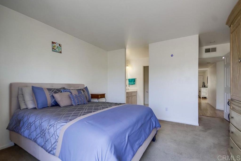 6454 Quarry Road, Unit 9 Spring Valley, CA 91977 - Photo 15 of 26 a bedroom with a large bed and a chandelier