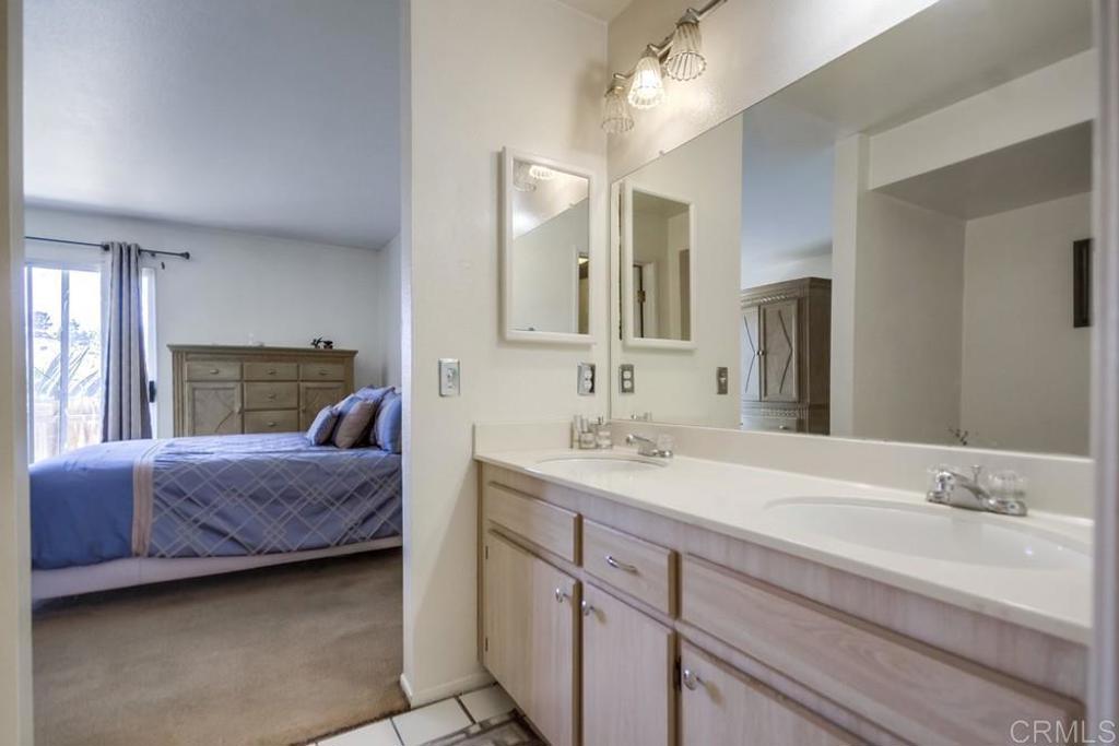 6454 Quarry Road, Unit 9 Spring Valley, CA 91977 - Photo 17 of 26 a en suite bathroom with a granite countertop sink and a mirror