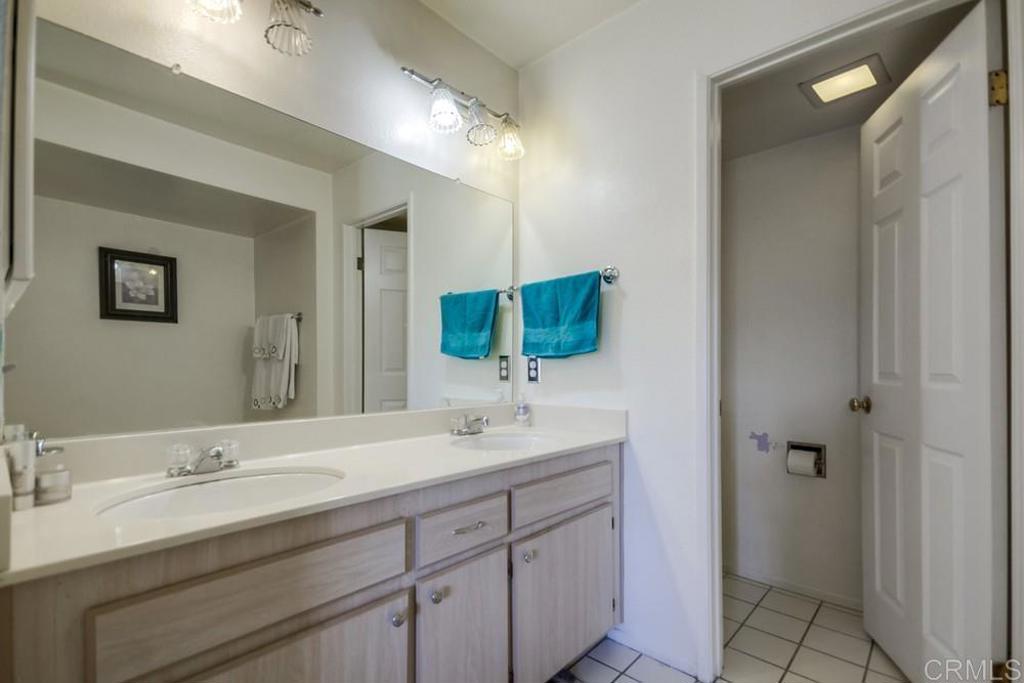 6454 Quarry Road, Unit 9 Spring Valley, CA 91977 - Photo 18 of 26 a bathroom with a double vanity sink mirror and