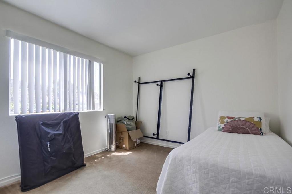 6454 Quarry Road, Unit 9 Spring Valley, CA 91977 - Photo 20 of 26 a bedroom with a bed and a couch