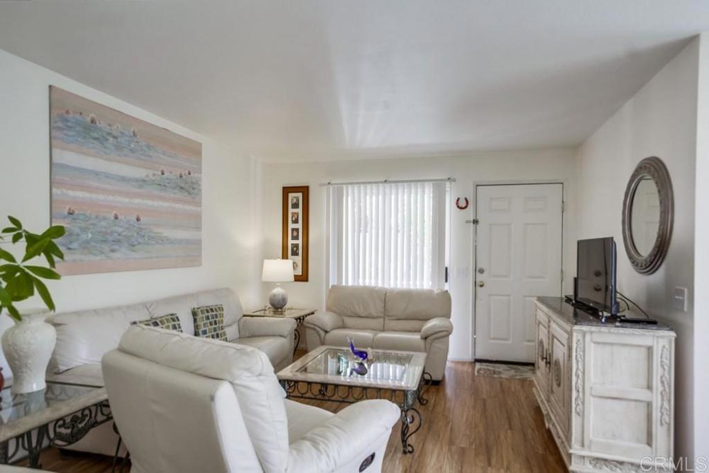 6454 Quarry Road, Unit 9 Spring Valley, CA 91977 - Photo 7 of 26 a living room with furniture a window and a wooden floor