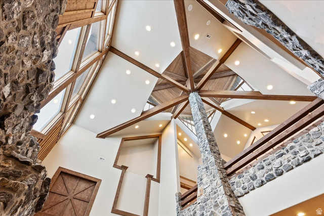 246 Woods Creek Road Morgan, UT 84050 - Photo 8 of 69 Vaulted ceilings featuring exposed wood beams, stone accents, recessed lighting, and expansive clerestory windows