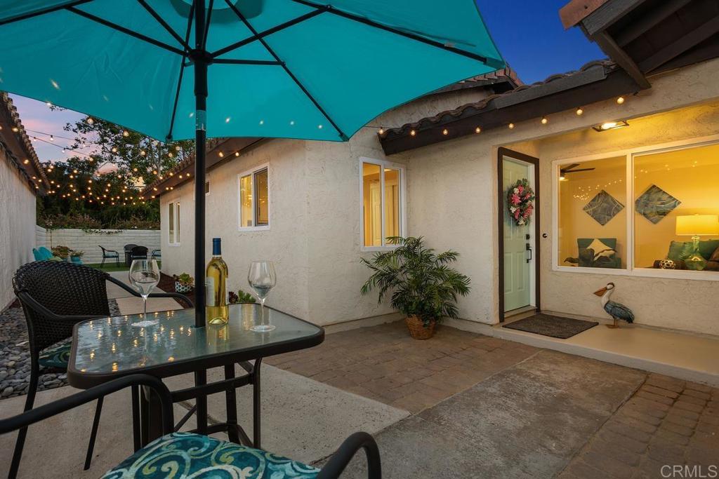 a patio table and chairs under an umbrella