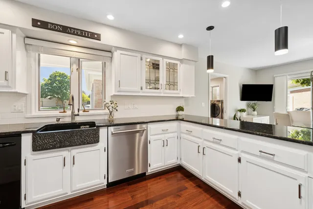 a room with pool table and windows