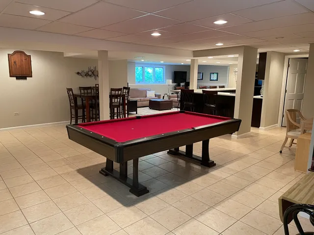 a living room with furniture kitchen view and a large window