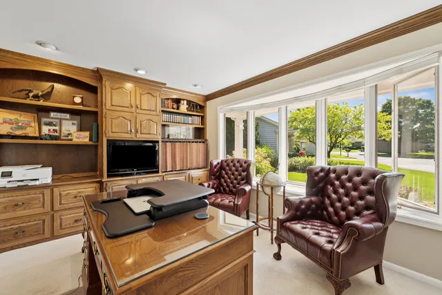 a living room with furniture flat screen tv and large window