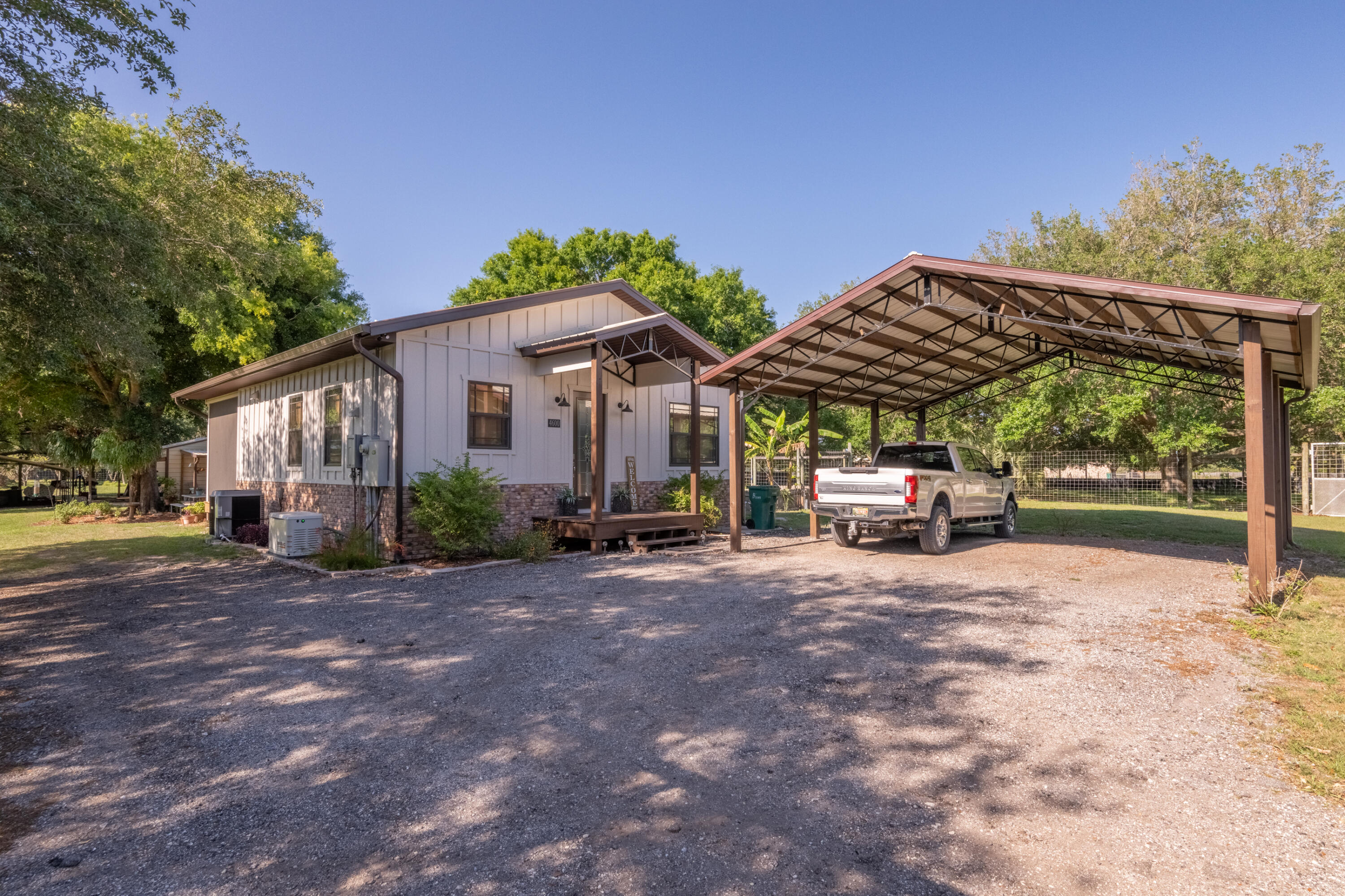 a view of a house with backyard and sitting area