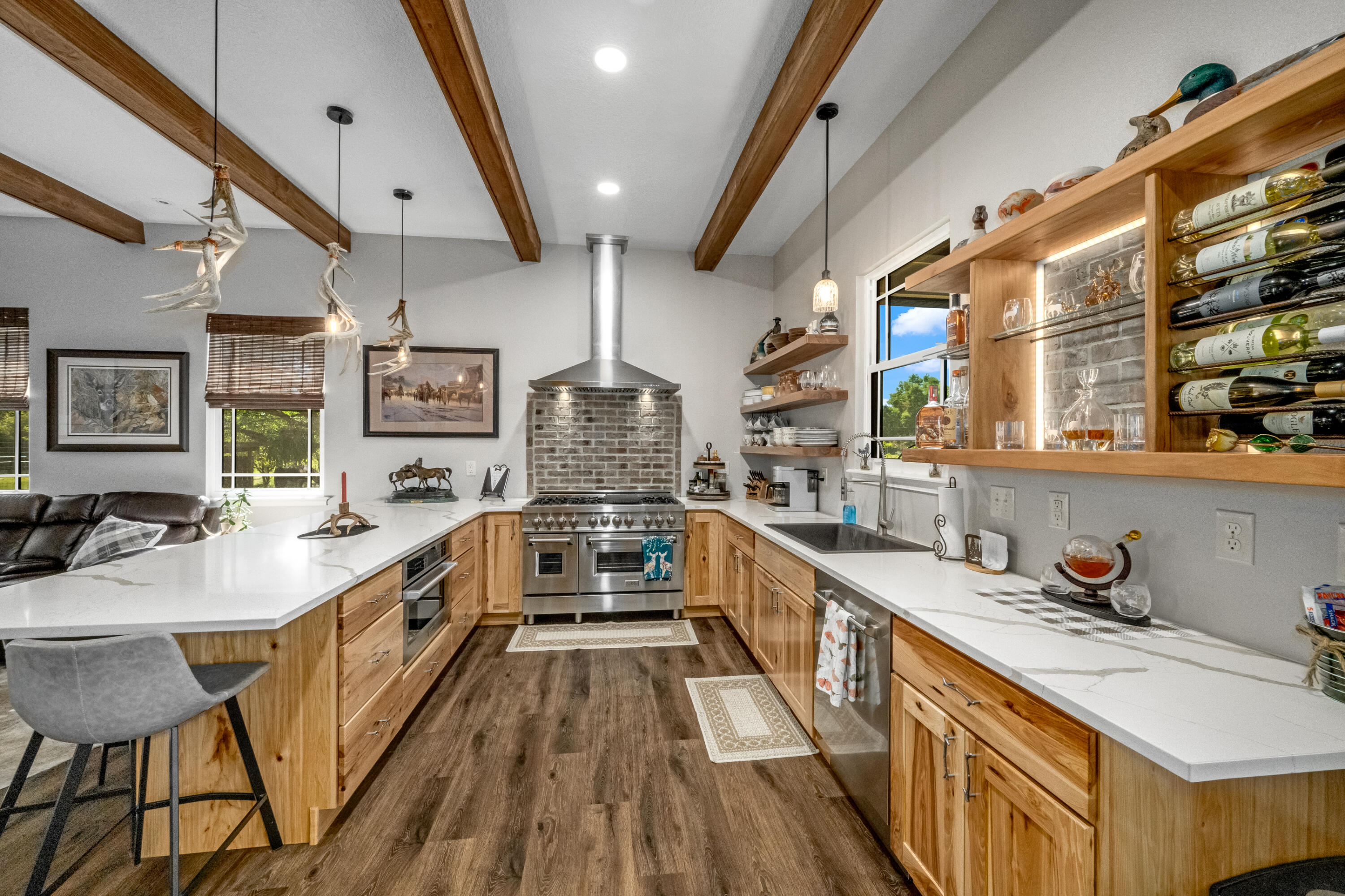 4600 Dixie Way Mims, FL 32754 - Photo 13 of 86 a kitchen with stainless steel appliances granite countertop a sink a stove and a wooden floors
