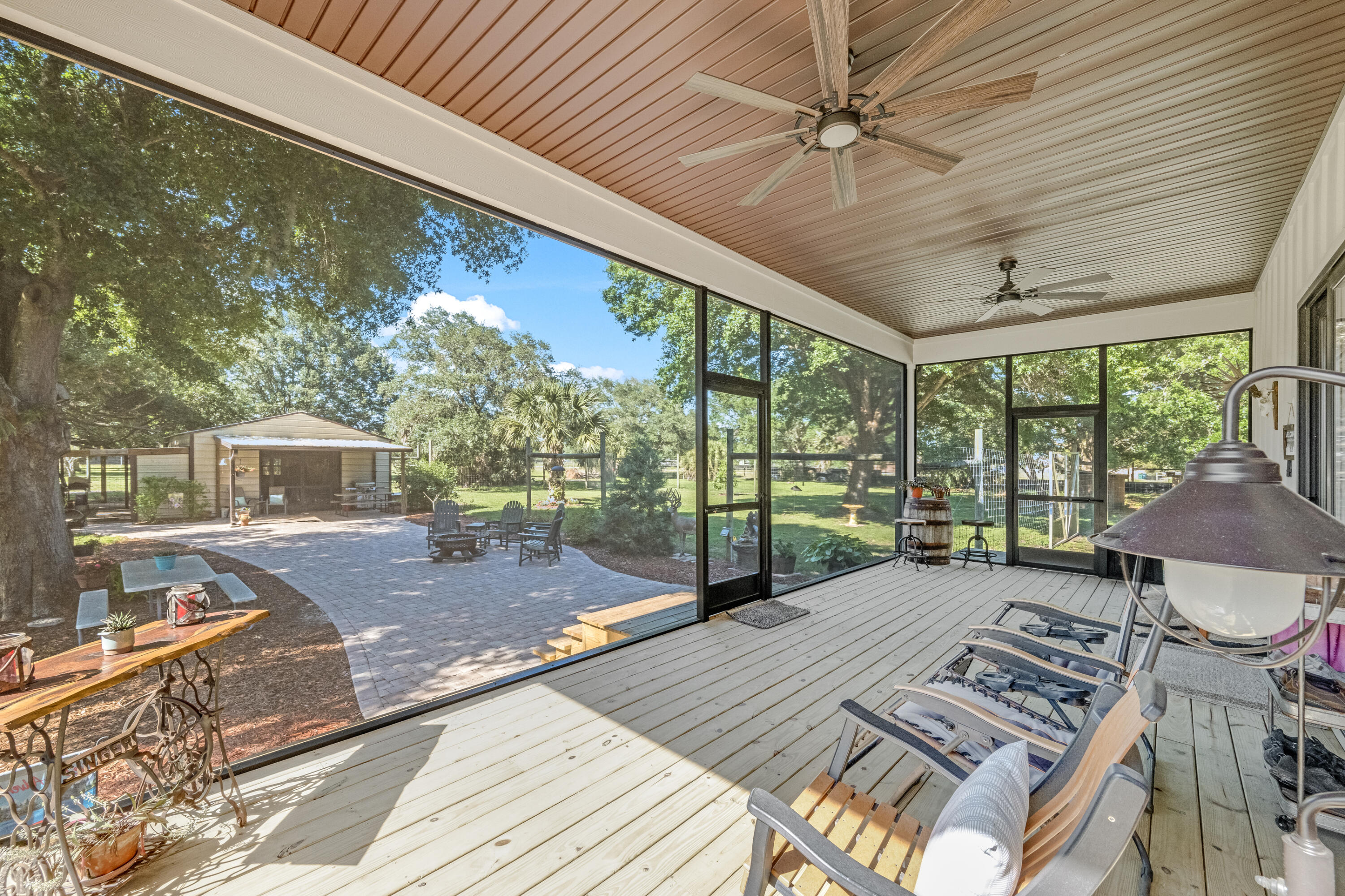 4600 Dixie Way Mims, FL 32754 - Photo 24 of 86 a view of a patio with a table chairs and wooden floor