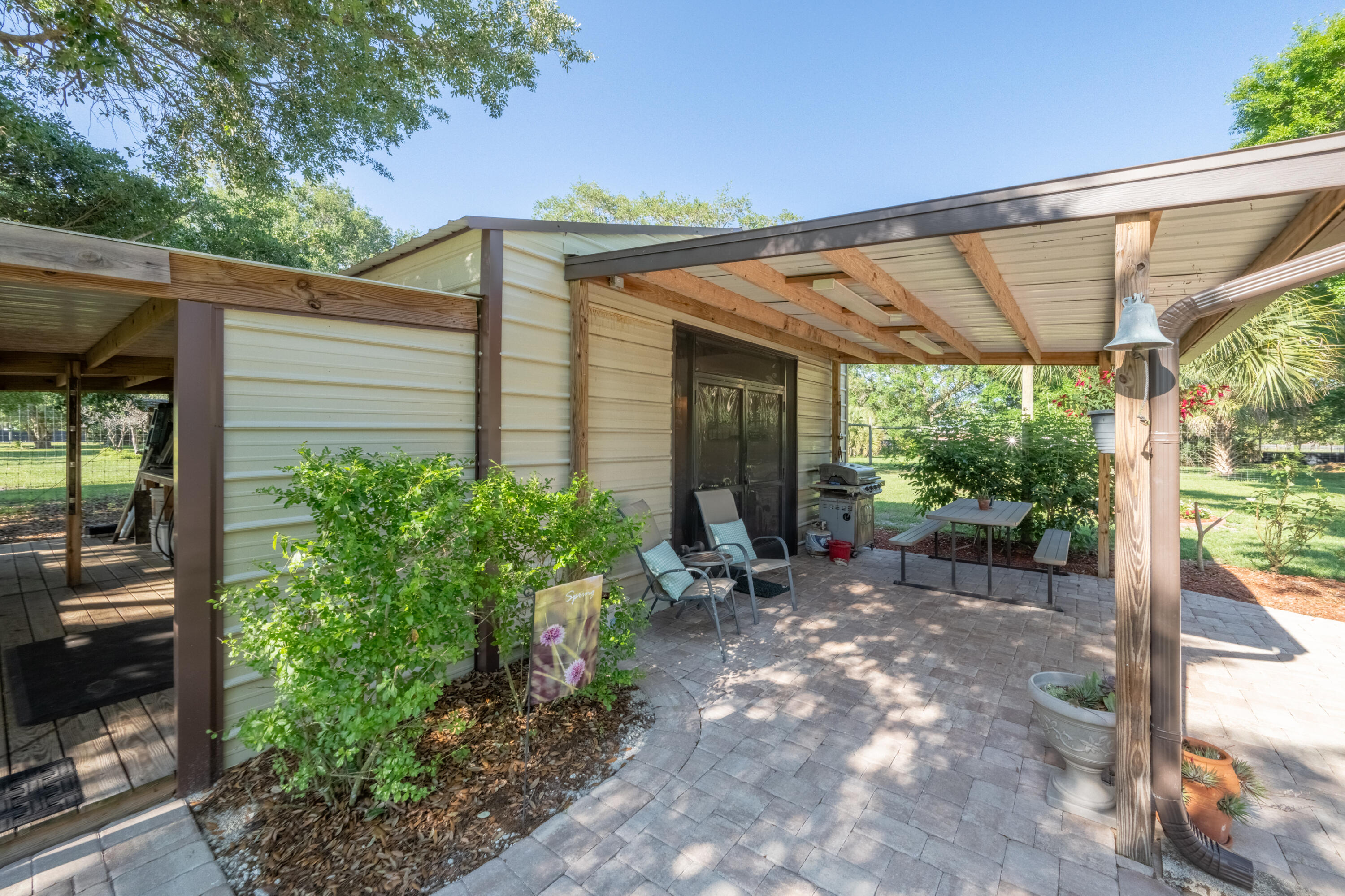 4600 Dixie Way Mims, FL 32754 - Photo 30 of 86 a view of a patio with a table and chairs under an umbrella