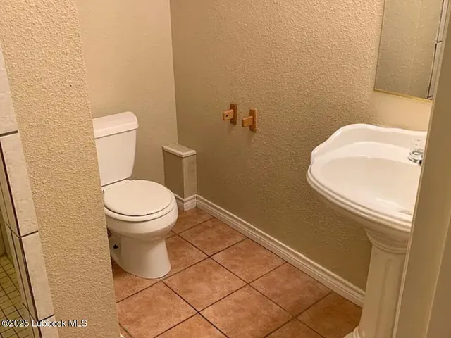 a white toilet sitting next to a sink