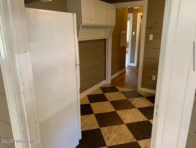 a bathroom with a black and white checkered floor