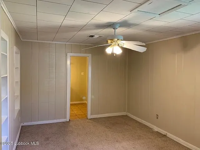 an empty room with a chandelier fan and closet