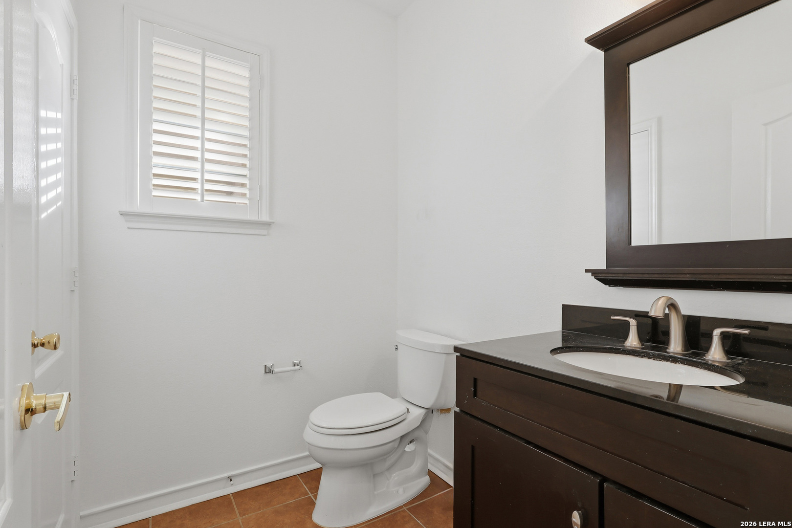 9348 Remuda Path San Antonio, TX 78254 - Photo 11 of 27 a bathroom with a granite countertop sink toilet and mirror