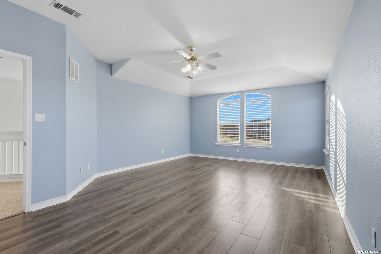 9348 Remuda Path San Antonio, TX 78254 - Photo 13 of 27 wooden floor in an empty room with a window