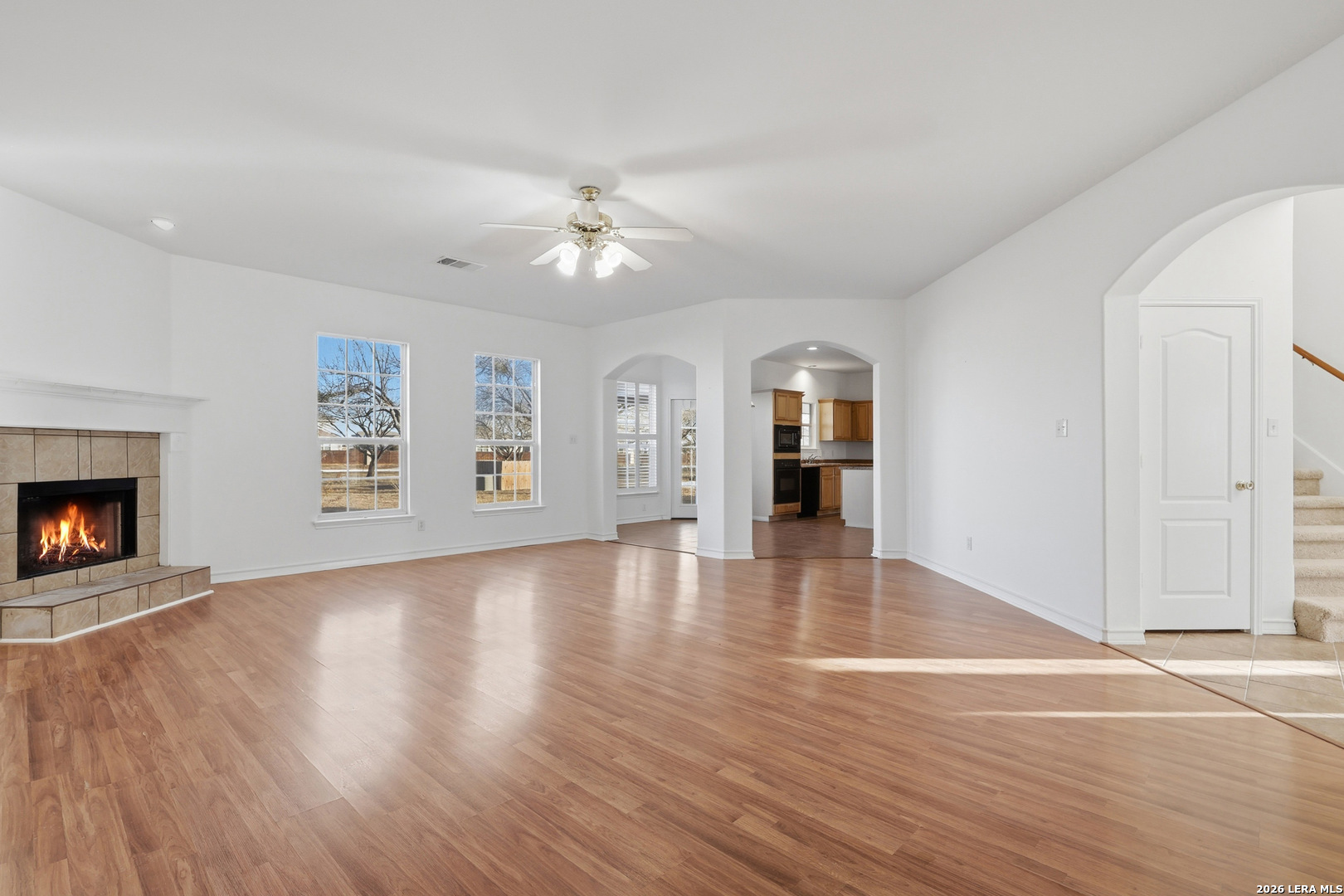 9348 Remuda Path San Antonio, TX 78254 - Photo 14 of 27 an empty room with large windows and fireplace