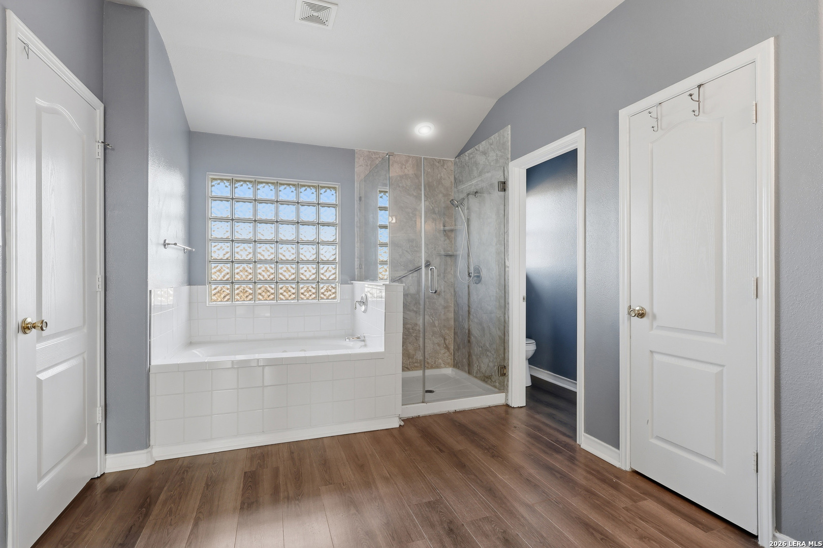 9348 Remuda Path San Antonio, TX 78254 - Photo 16 of 27 a view of an empty room with wooden floor and a window