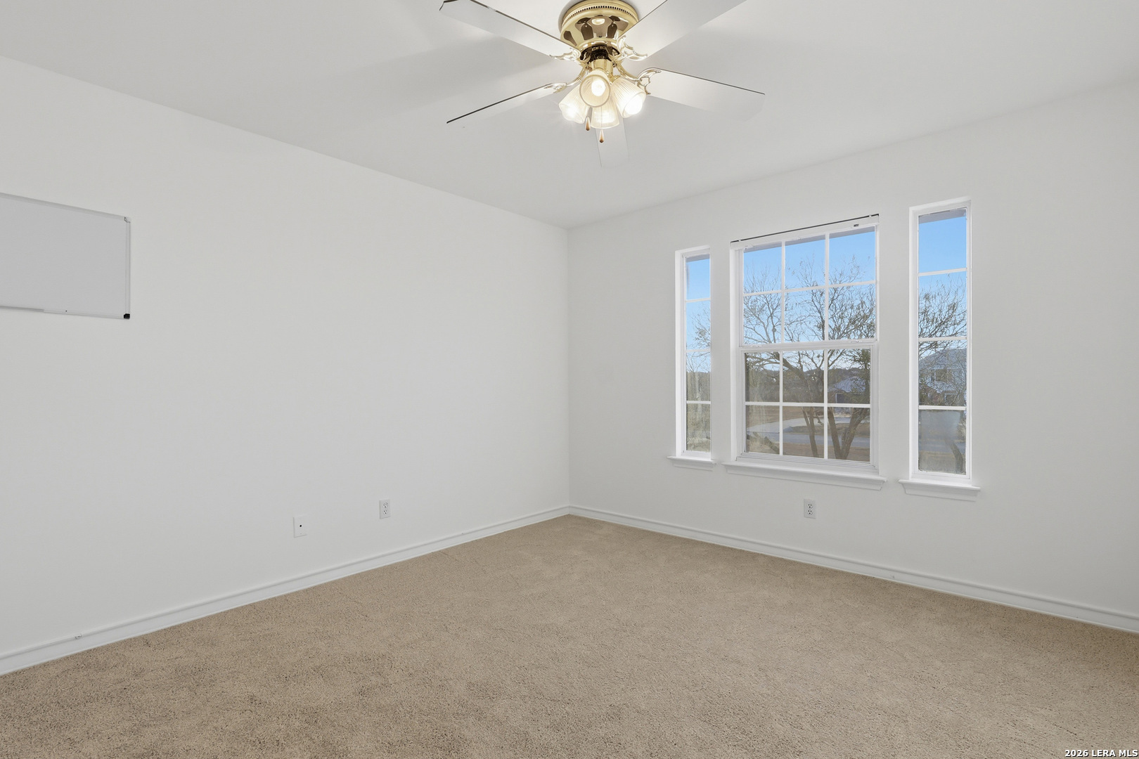 9348 Remuda Path San Antonio, TX 78254 - Photo 21 of 27 an empty room with a window and a fan