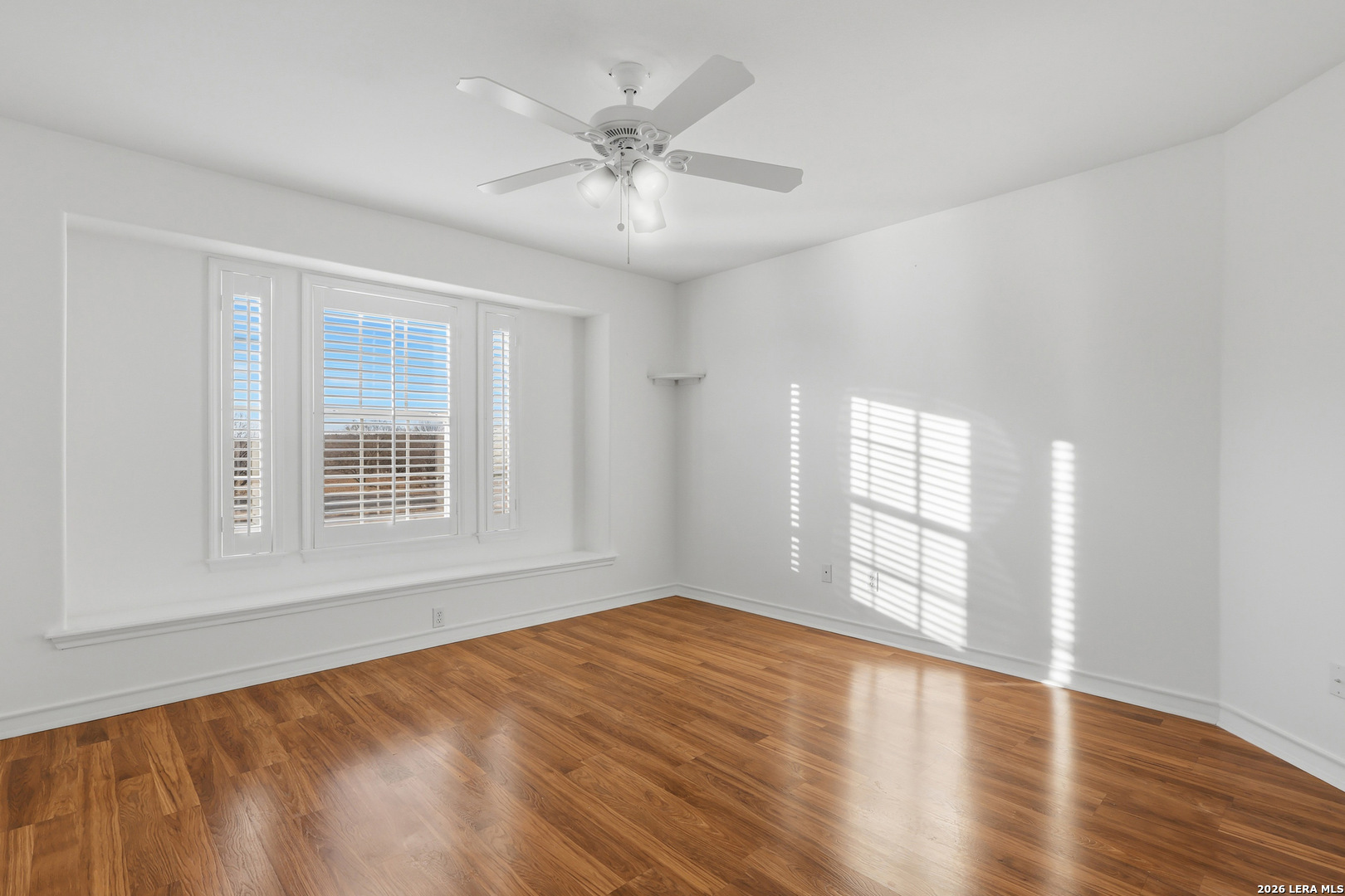 9348 Remuda Path San Antonio, TX 78254 - Photo 23 of 27 wooden floor in an empty room with a window