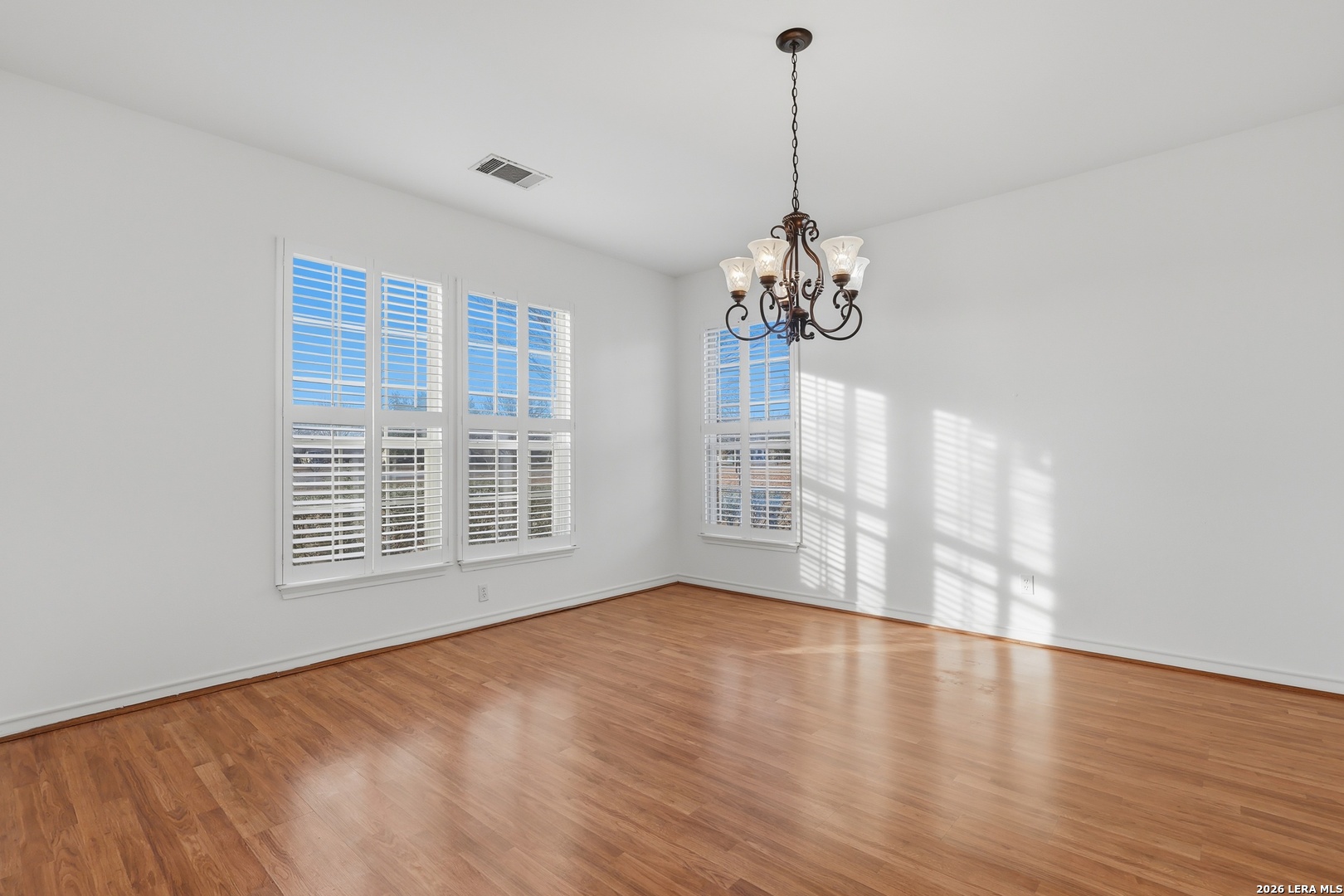 9348 Remuda Path San Antonio, TX 78254 - Photo 3 of 27 a view of an empty room with wooden floor and a window