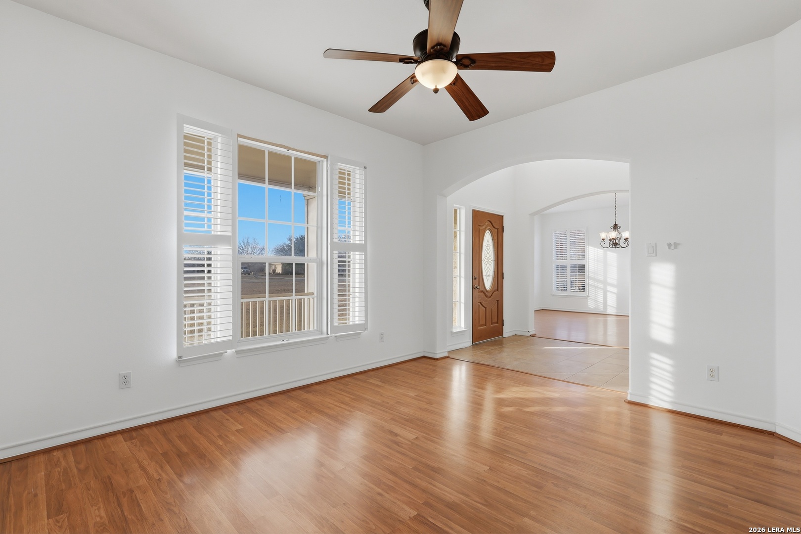 9348 Remuda Path San Antonio, TX 78254 - Photo 4 of 27 a view of an empty room with window and wooden floor