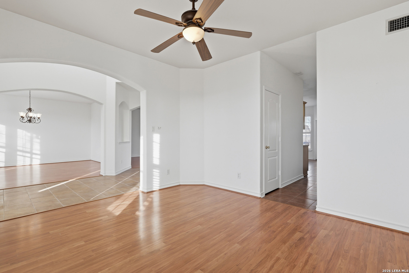 9348 Remuda Path San Antonio, TX 78254 - Photo 5 of 27 wooden floor in an empty room with a window