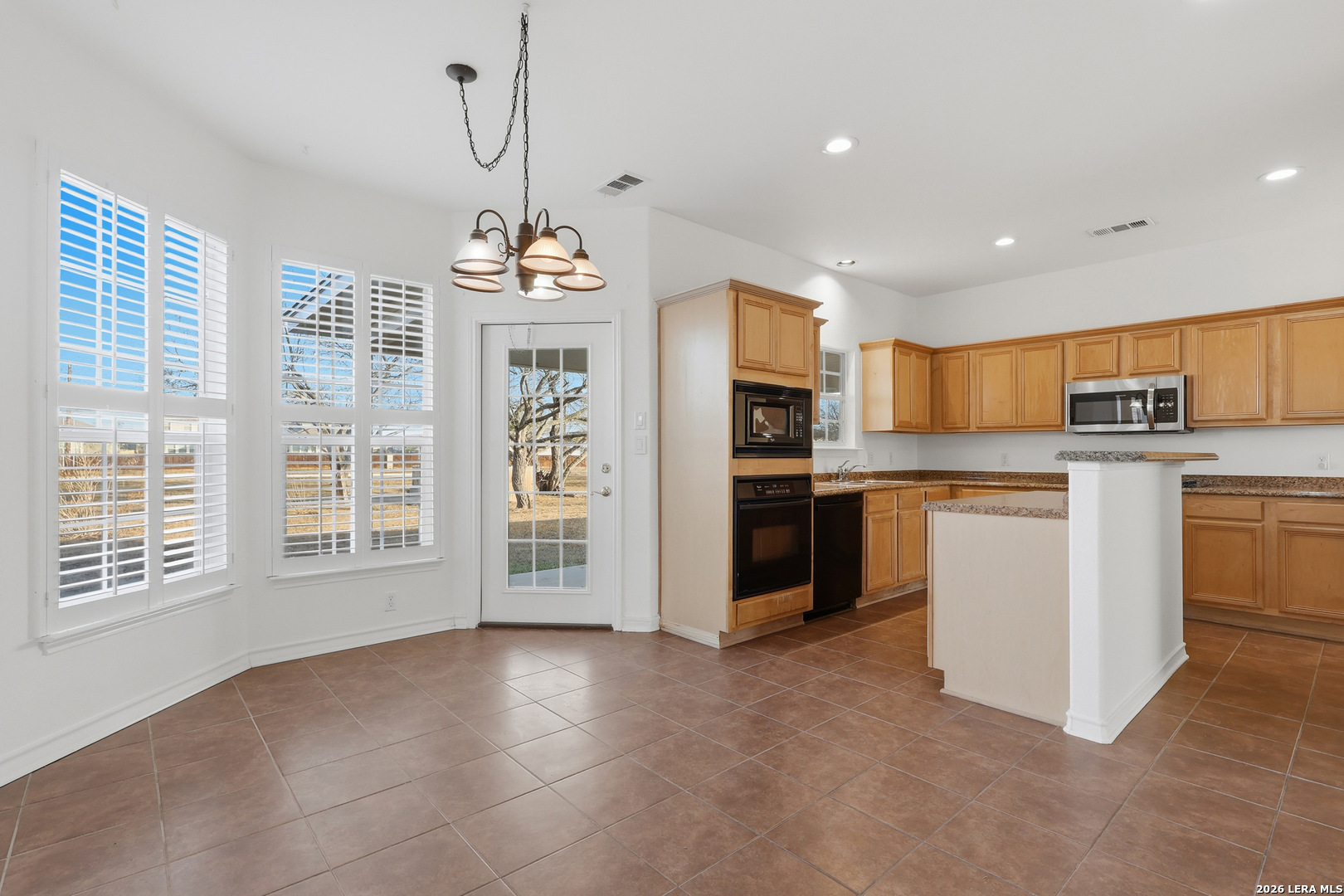 9348 Remuda Path San Antonio, TX 78254 - Photo 6 of 27 a view of a kitchen with stove top oven and cabinets
