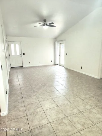 a view of a room has white walls and tiles