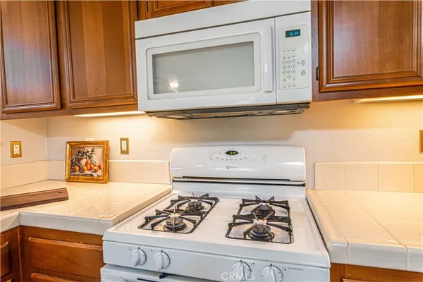 a kitchen with granite countertop cabinets and black appliances