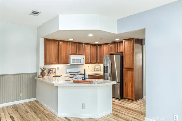a kitchen with stainless steel appliances a refrigerator sink and cabinets