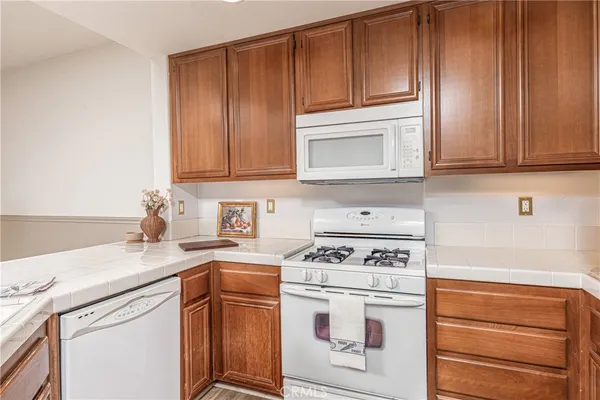 a kitchen with granite countertop cabinets stainless steel appliances and sink