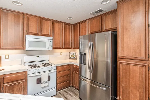 a kitchen with cabinets stainless steel appliances and a window