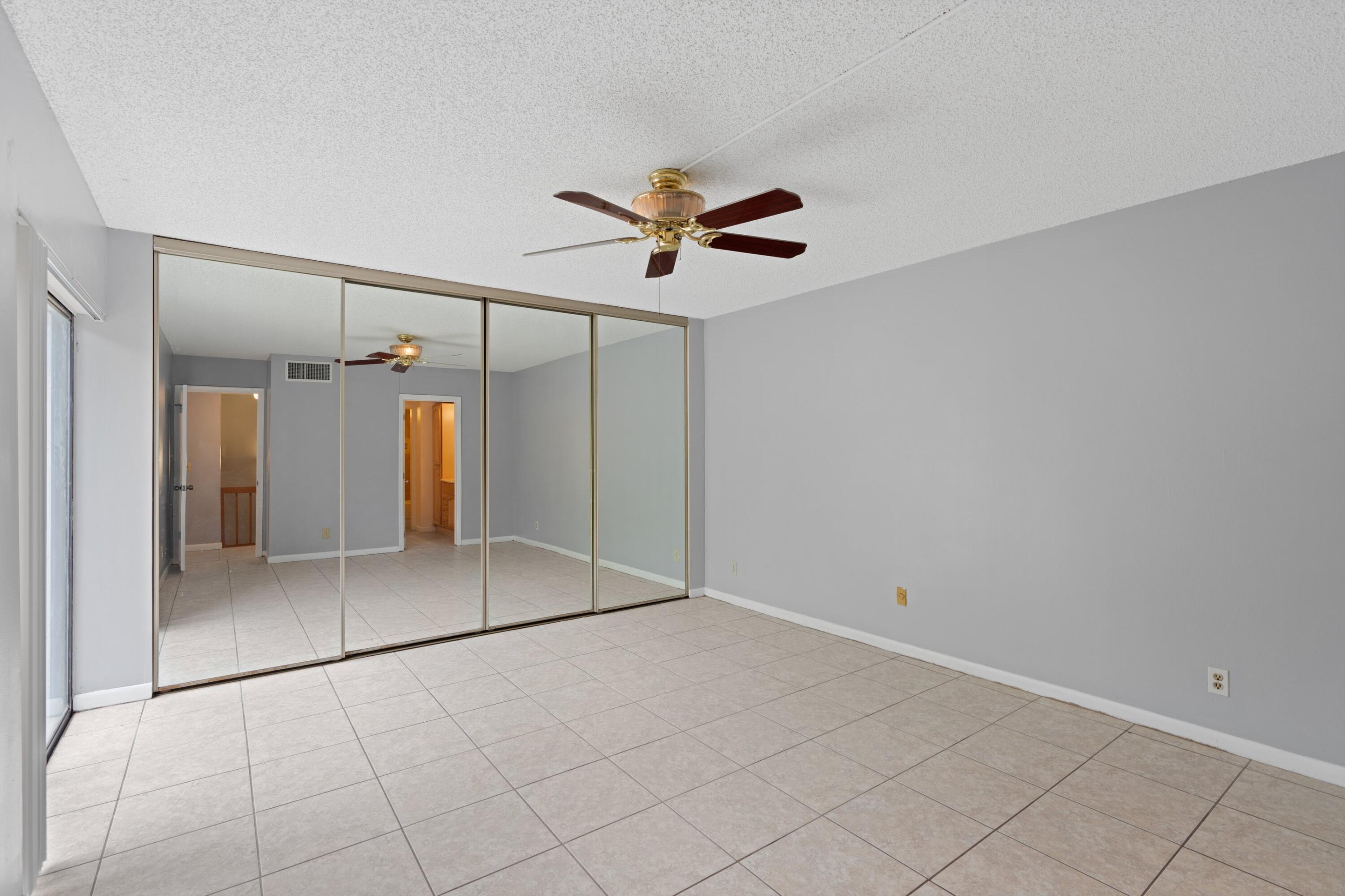 2247 White Pine Circle, Unit A Greenacres, FL 33415 - Photo 16 of 27 an empty room with fan and windows