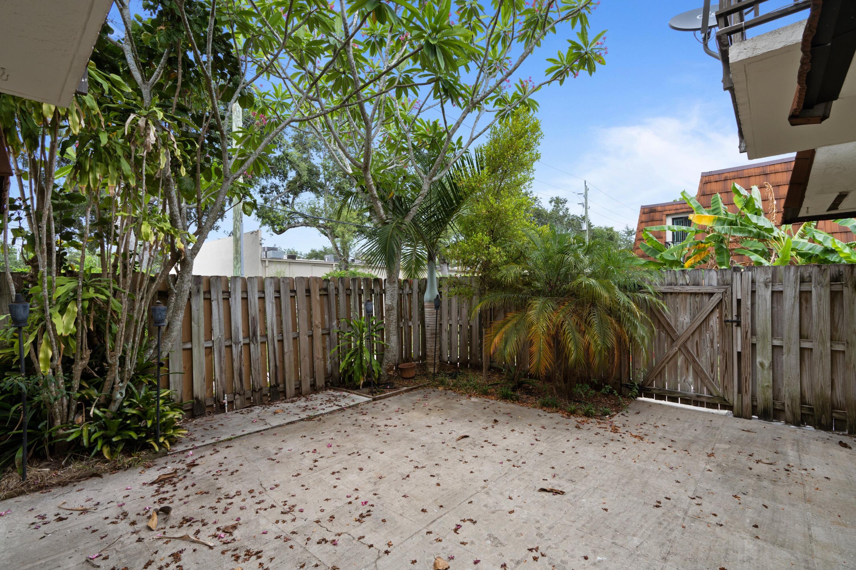 2247 White Pine Circle, Unit A Greenacres, FL 33415 - Photo 19 of 27 a backyard of a house with lots of green space