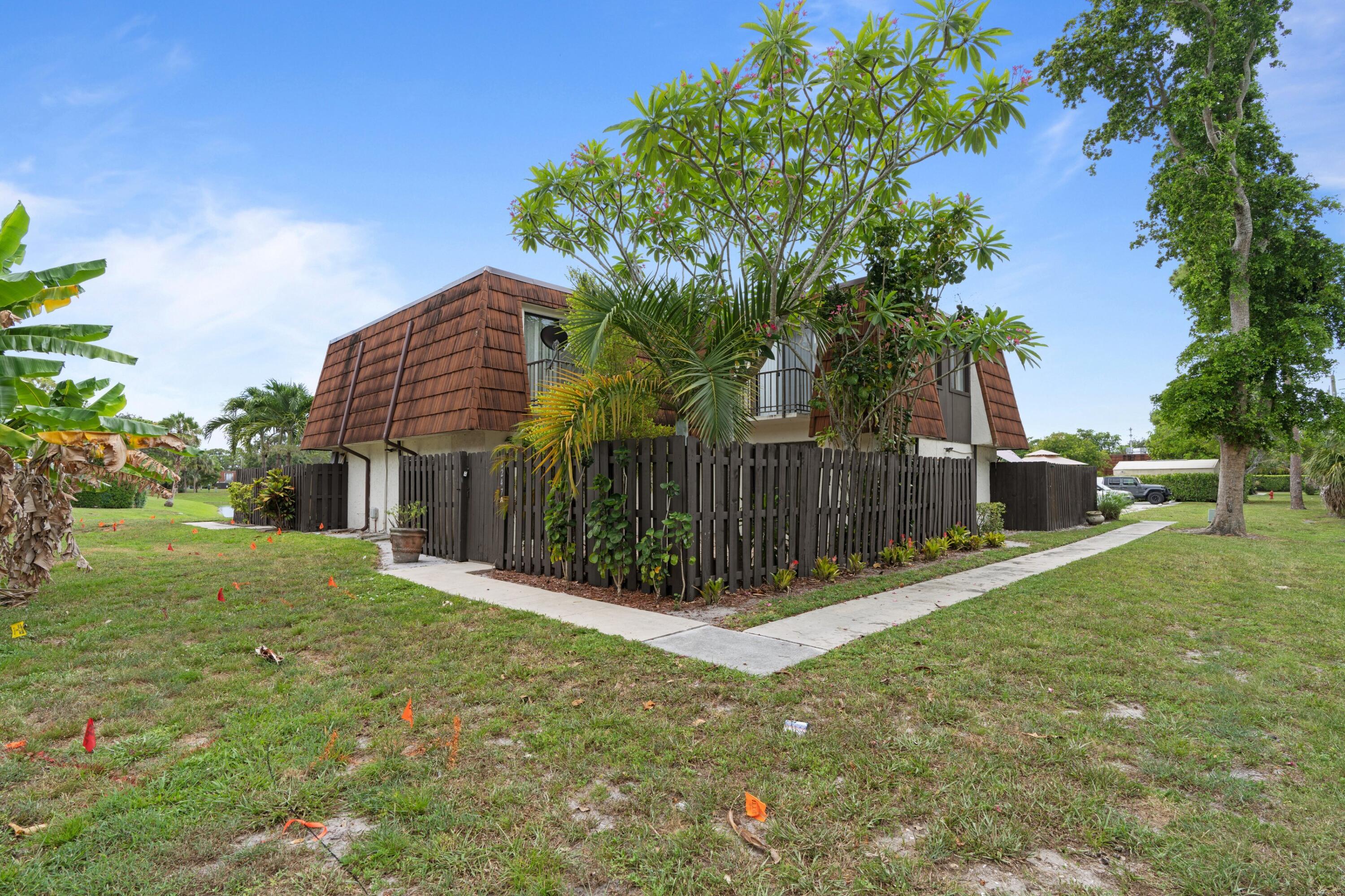 2247 White Pine Circle, Unit A Greenacres, FL 33415 - Photo 2 of 27 a view of a house with a yard