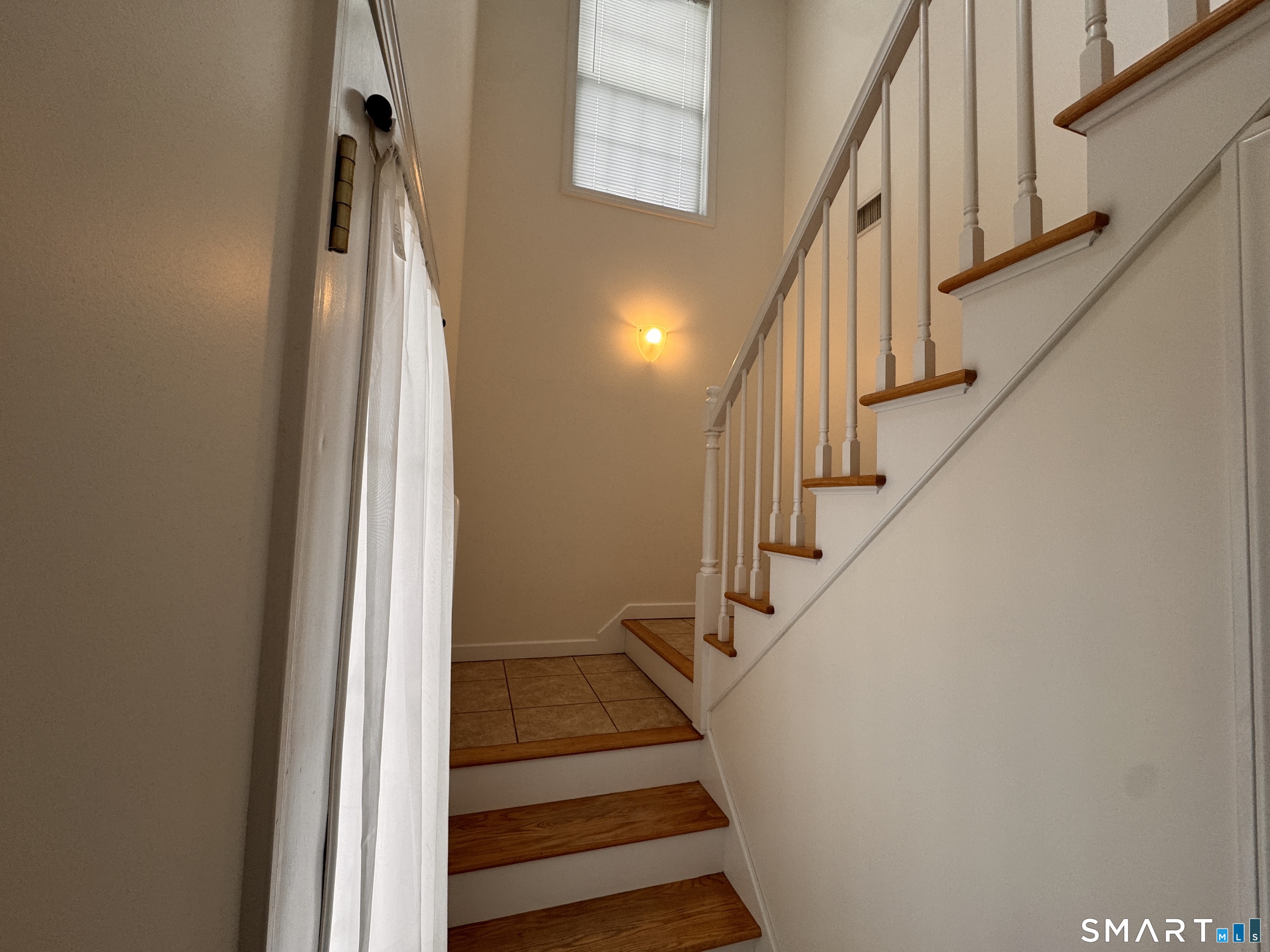 128 Meridian Street, Unit 211 Groton, CT 06340 - Photo 15 of 23 a view of staircase with wooden floor and a rug
