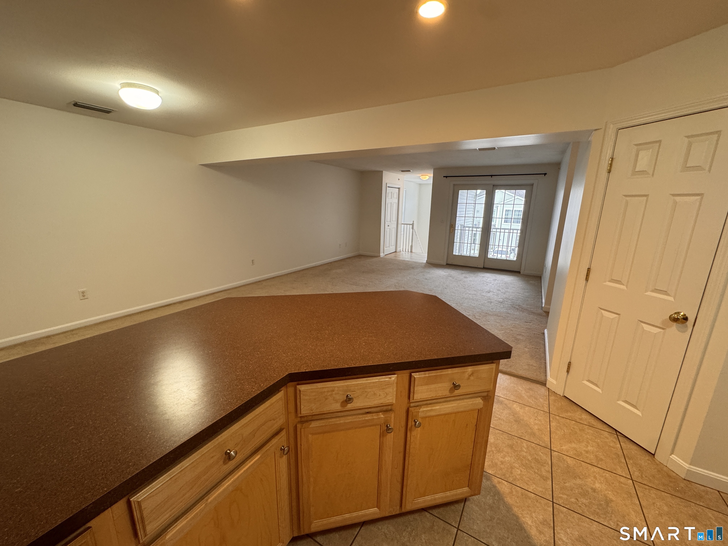128 Meridian Street, Unit 211 Groton, CT 06340 - Photo 18 of 23 a view of a kitchen with wooden floor and staircase