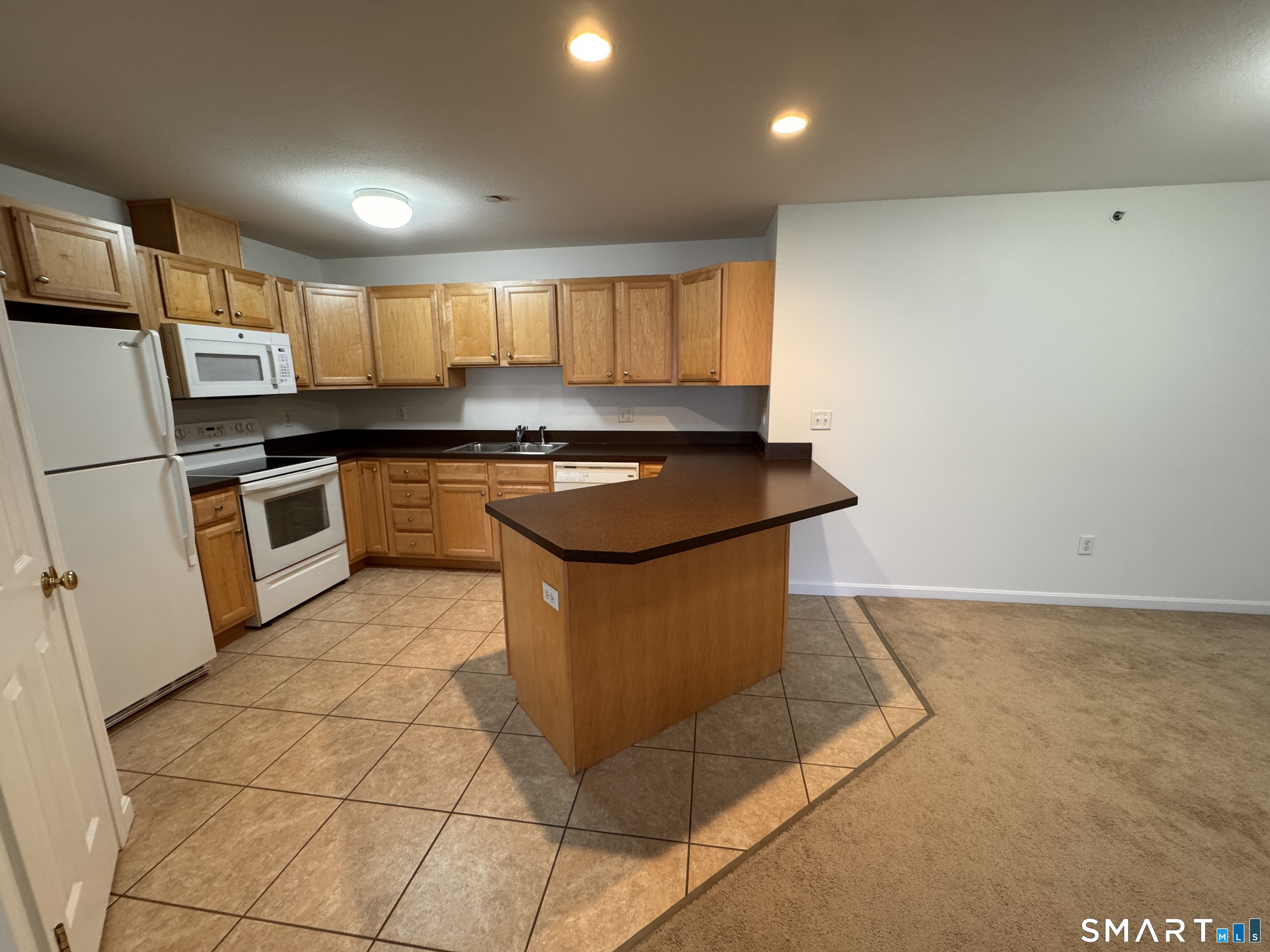 128 Meridian Street, Unit 211 Groton, CT 06340 - Photo 19 of 23 a kitchen with stainless steel appliances granite countertop a stove a sink and a refrigerator