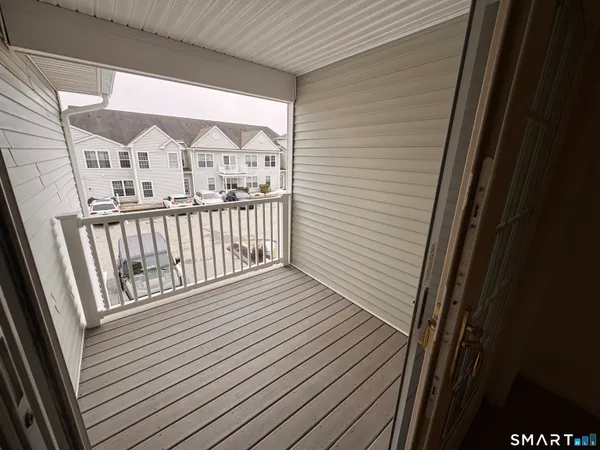 a view of a balcony with wooden floor