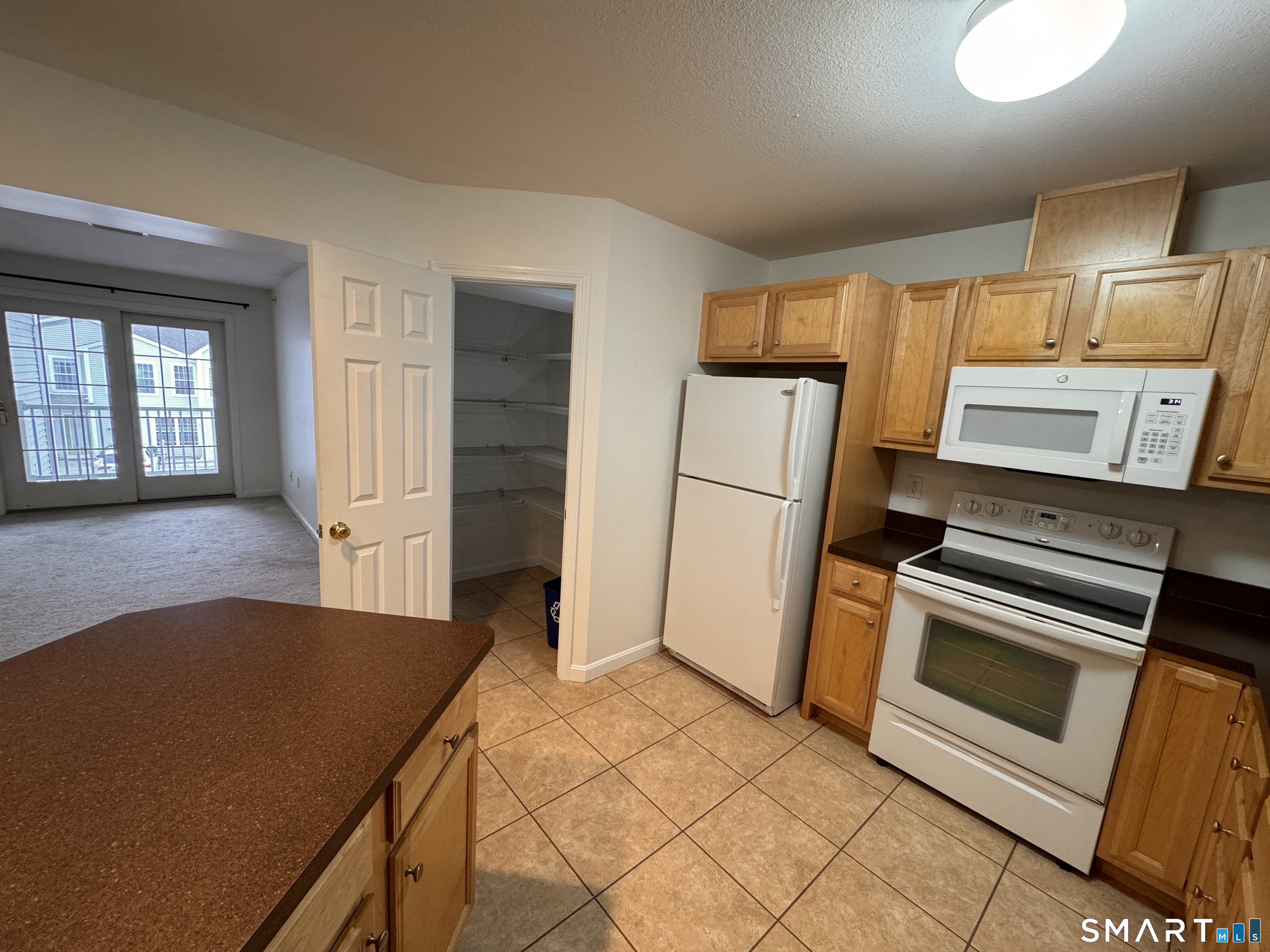 128 Meridian Street, Unit 211 Groton, CT 06340 - Photo 21 of 23 a kitchen with a refrigerator and a stove top oven