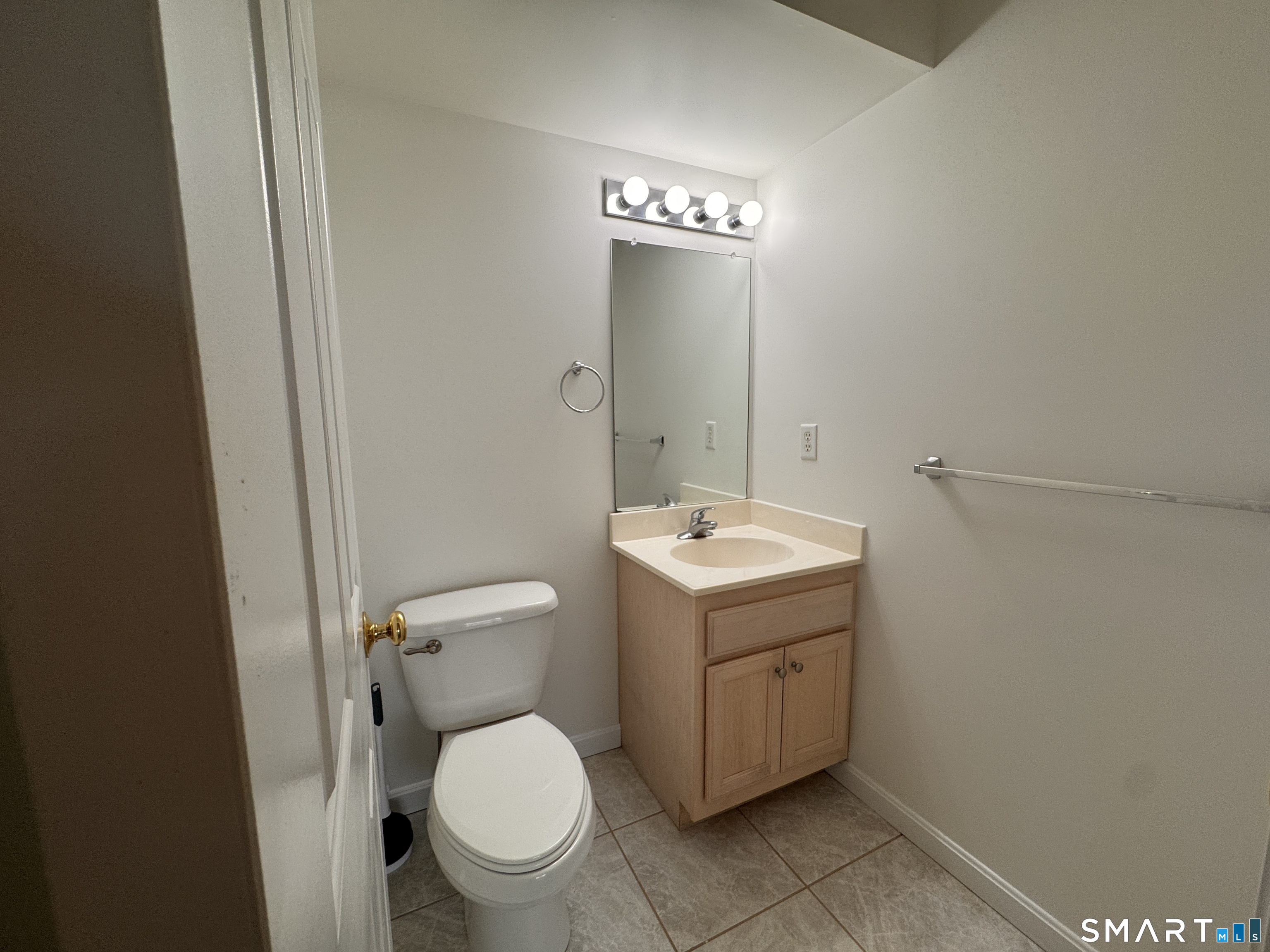 128 Meridian Street, Unit 211 Groton, CT 06340 - Photo 4 of 23 a bathroom with a toilet sink and mirror
