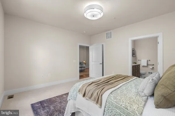 a bedroom with a bed and a mirror