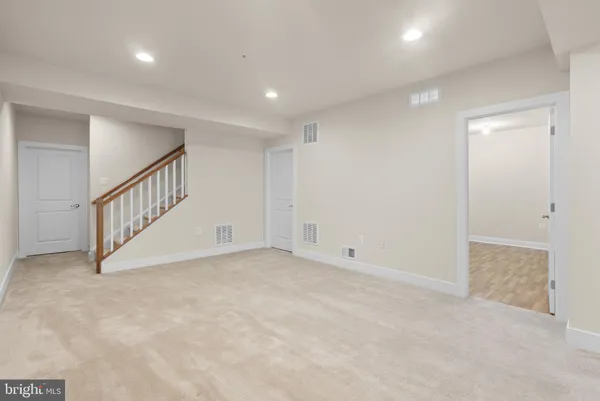 a view of an empty room with stairs