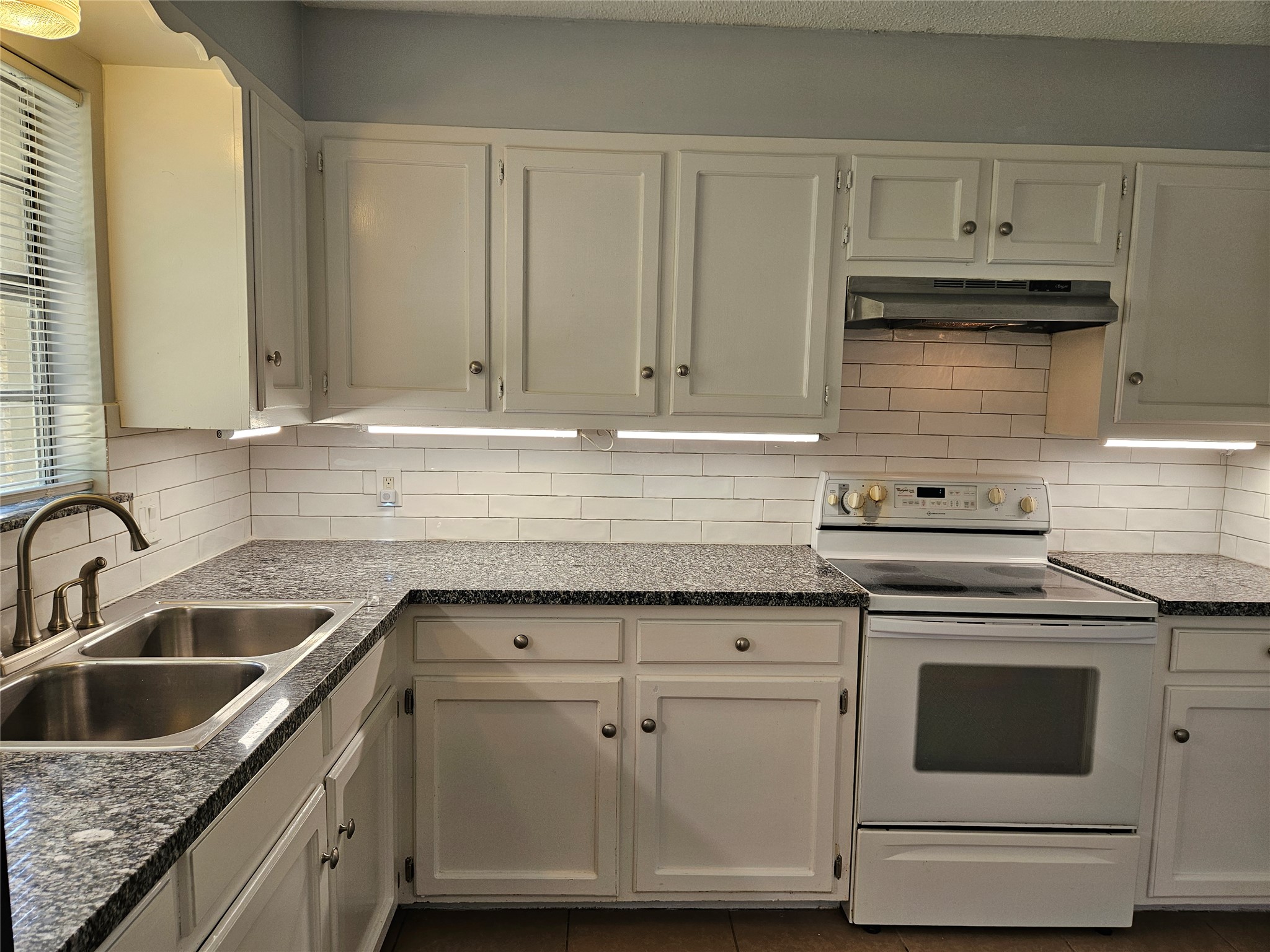 806 Ranch Road, Unit A Georgetown, TX 78628 - Photo 8 of 24 A well-appointed kitchen features ample granite counter space and a classic range, ready for culinary endeavors.