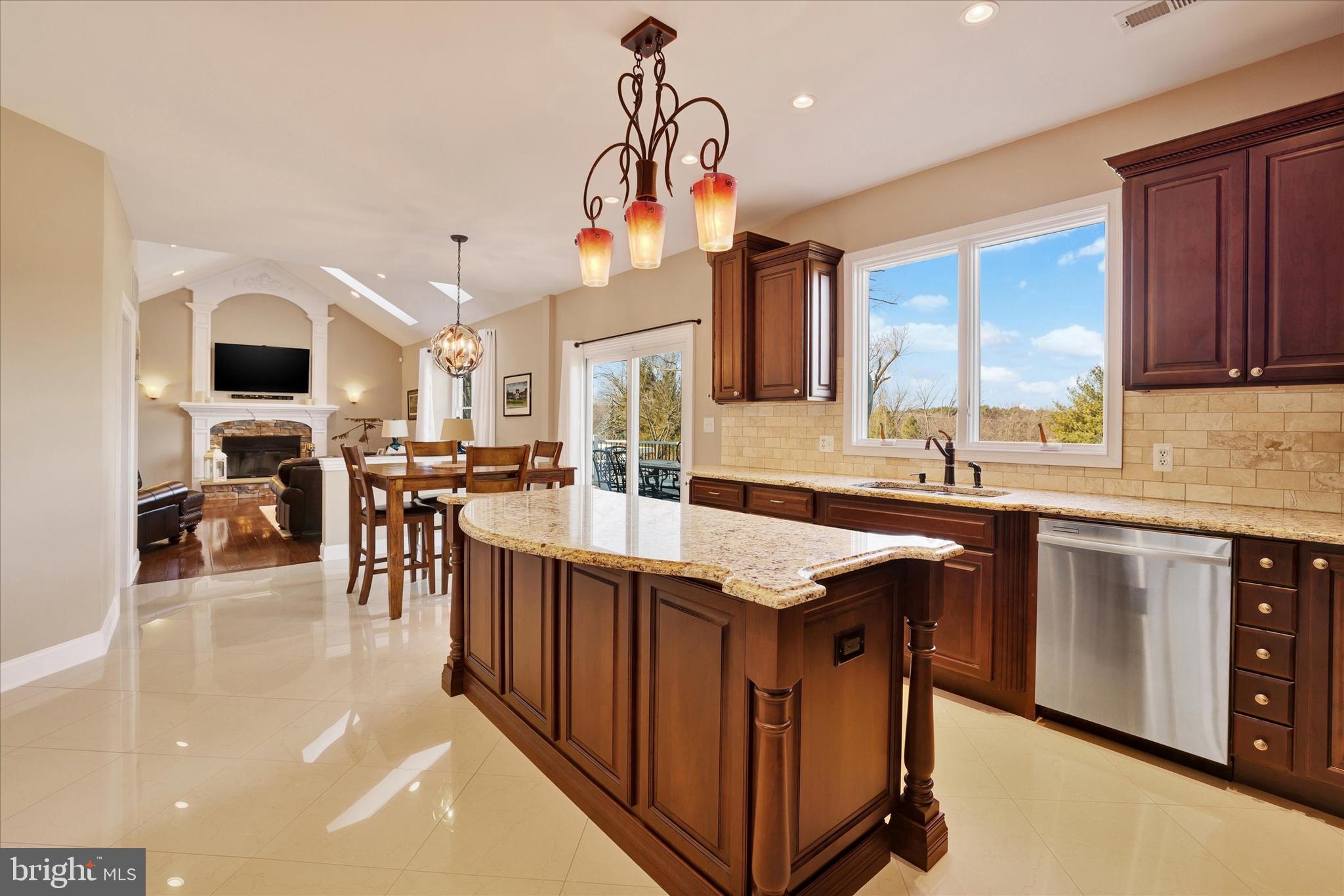 131 Hope Road Holland, PA 18966 - Photo 12 of 55 a kitchen with stainless steel appliances granite countertop a sink a stove and a wooden floors